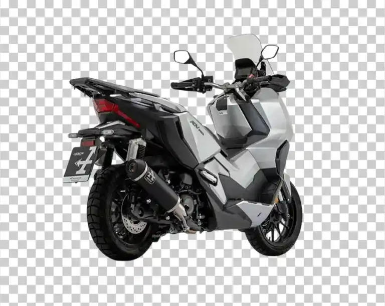 A rear-quarter view of a white Honda ADV350 motorcycle with a top box and a custom exhaust.