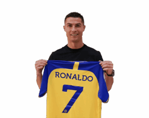 Cristiano Ronaldo holding his Al Nassr FC jersey with 'RONALDO 7' on the back, smiling, with a transparent background.