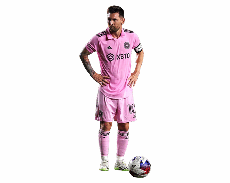 Full body shot of Lionel Messi in the Inter Miami CF pink home kit with a ball at his feet, standing on a transparent background.