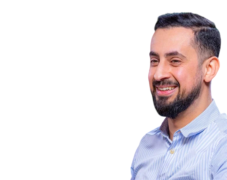 Headshot of Mehmet Yıldız, a Turkish speaker and digital content creator, smiling broadly in a light blue striped shirt, on a transparent background.